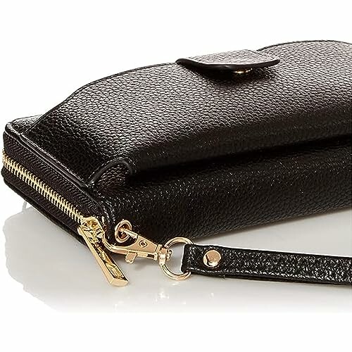 Close-up of a black leather wallet with a zipper and wrist strap, showcasing the stylish design and practical features