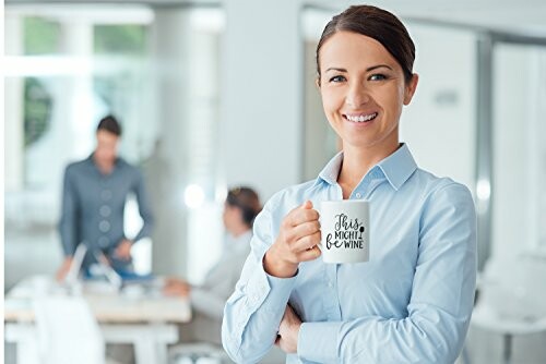 Businesswoman holding a mug in an office setting.