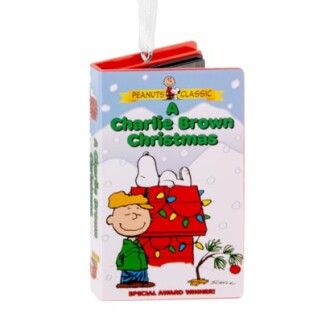 A Charlie Brown Christmas book ornament featuring Snoopy and Charlie Brown.