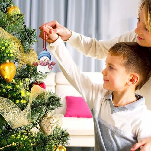 Child and adult decorating a Christmas tree with ornaments.
