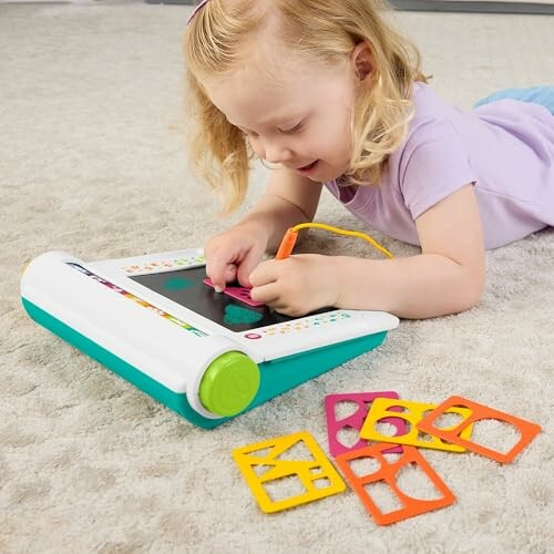 Child playing with a drawing toy on carpet.