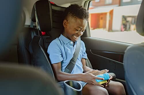 Child enjoying the Buffalo Games Pop It Pro in a car seat.