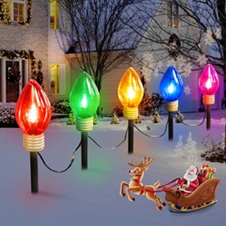 Colorful Christmas light decorations in a snowy garden with Santa and reindeer.
