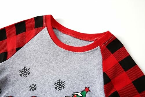Christmas-themed shirt with red plaid sleeves and snowflake design.