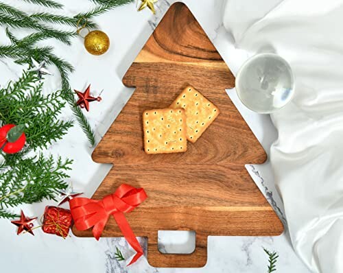 Christmas tree cutting board with crackers and decorations