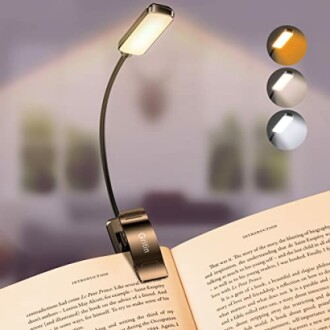 Clip-on reading light with adjustable color temperatures illuminating a book.