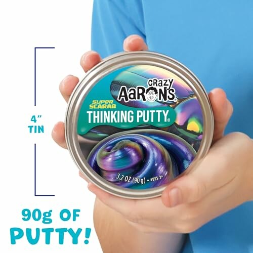 Person holding Crazy Aaron's Thinking Putty tin.