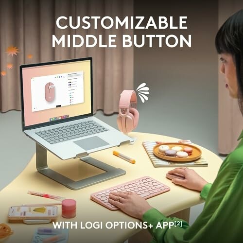Person customizing mouse with software on laptop.