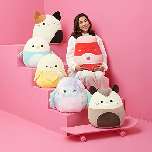 Woman sitting on pink stairs with colorful plush toys.