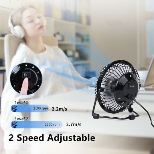 Desk fan with two adjustable speed settings and a person wearing headphones.