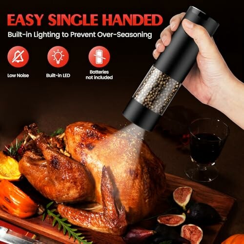 Electric pepper grinder seasoning roasted turkey on a wooden board.
