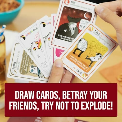 Person holding Exploding Kittens cards with game slogan.