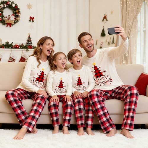 Family in matching Christmas pajamas taking a selfie.