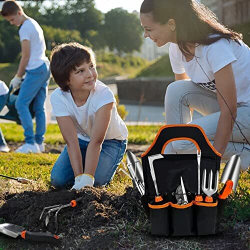 A family gardening with tools and soil outdoors.