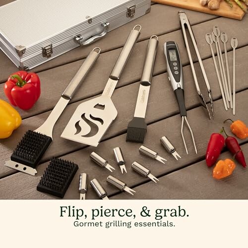 Collection of grilling tools and accessories on a wooden table
