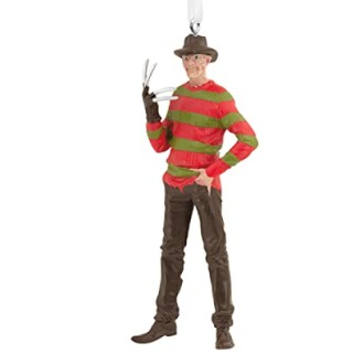 Ornament of a horror movie character with clawed glove and hat.