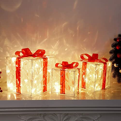 Three illuminated gift boxes with red bows on a shelf.
