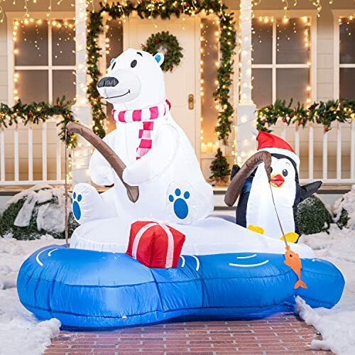 Inflatable polar bear and penguin with fishing rods and gift on a blue raft.