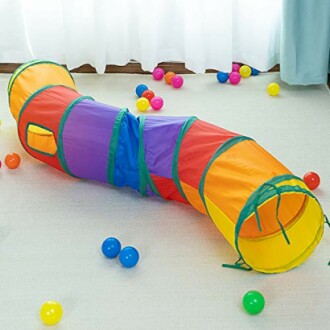 Colorful kids play tunnel with scattered balls on the floor.