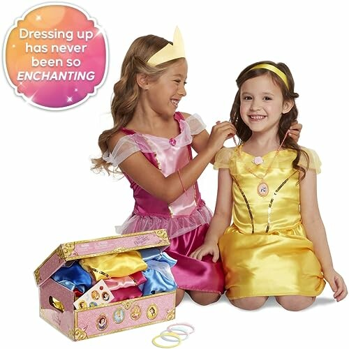 Two children dressed as princesses with a dress-up kit.