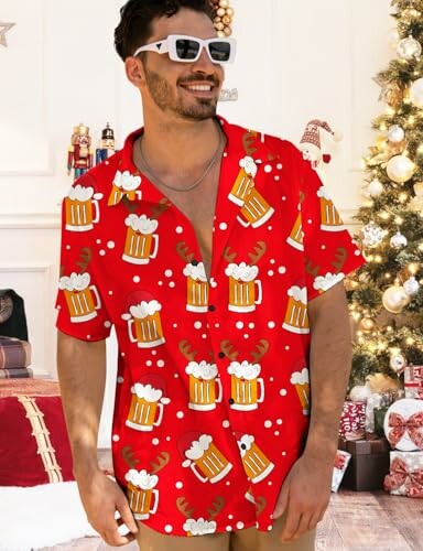 Man wearing a festive red shirt with beer mug pattern, standing in a Christmas-themed setting.