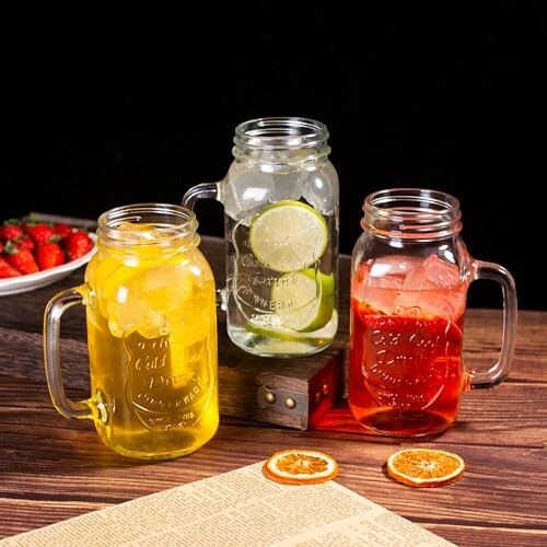 Three mason jars with colorful drinks and citrus slices.
