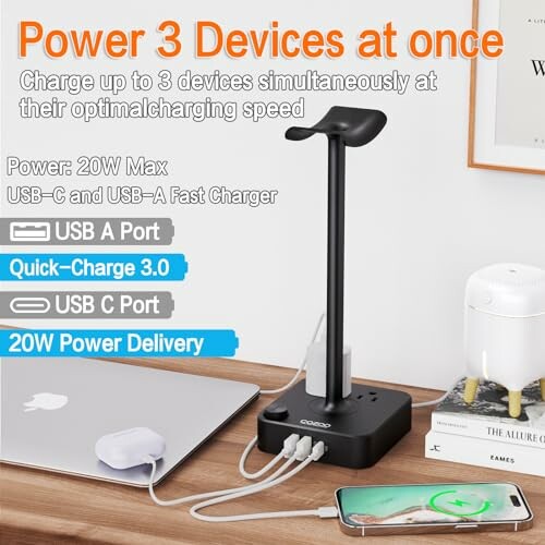 Multi-device charging station on desk with phone, laptop, and lamp.