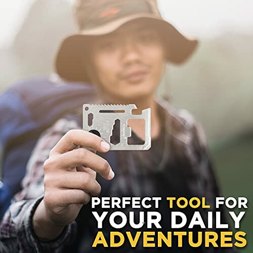 Person holding a multi-tool card outdoors with a backpack.