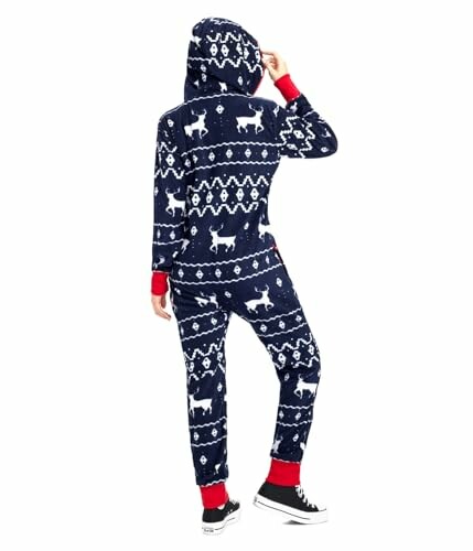 Person wearing a navy fleece onesie with reindeer pattern, red cuffs, and a hood