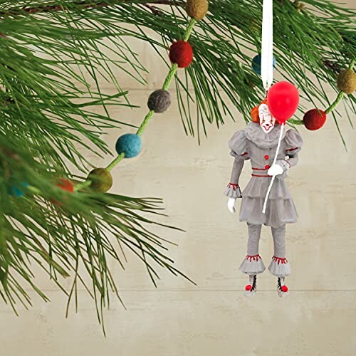 Pennywise ornament with balloon on pine tree