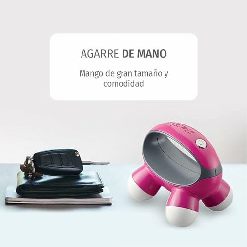 Portable hand grip device next to keys and wallet, perfect for tossing in your purse or bag.