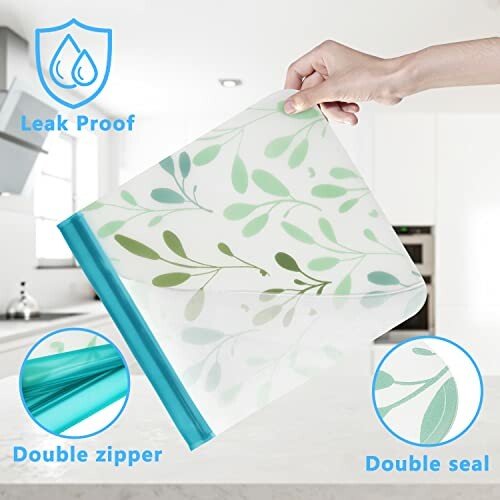 Hand holding a reusable leak-proof food storage bag with leaf pattern, featuring double zipper and seal.