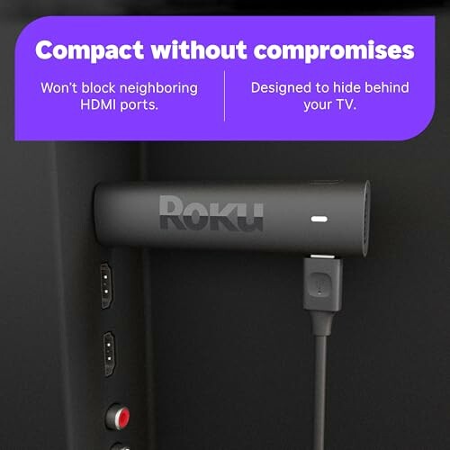 Roku streaming stick connected to TV, compact design.