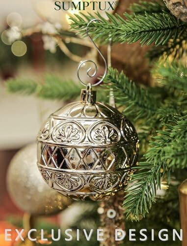 Silver ornament hanging on Christmas tree branch