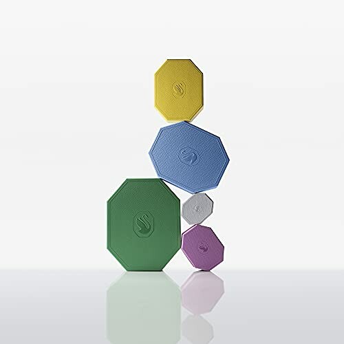 Stacked colorful geometric shapes on a plain background
