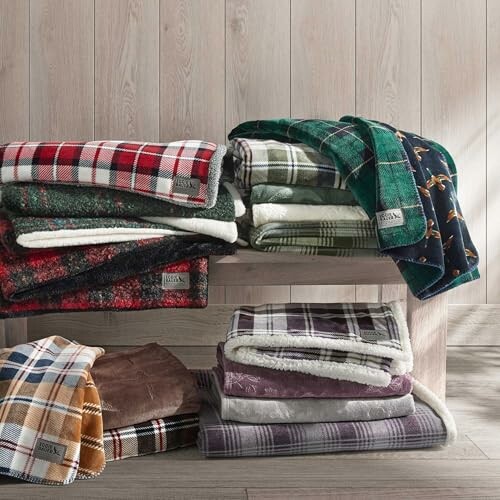 Stacked plaid fleece blankets on wooden shelves.