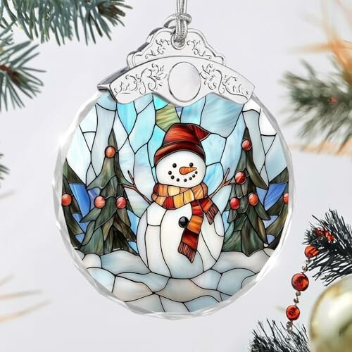 Stained glass ornament depicting a snowman with trees.