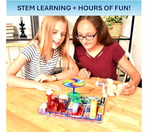 Two girls enjoying a STEM electronics kit at a table.