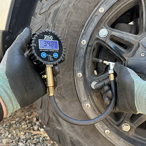 Person using a pressure gauge to check tire pressure.