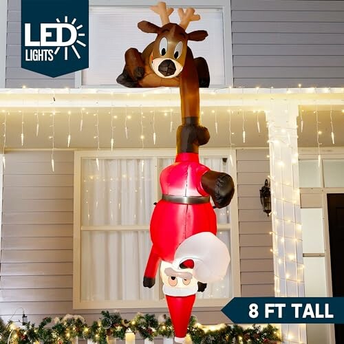 Inflatable upside-down reindeer and Santa decoration in front of a house