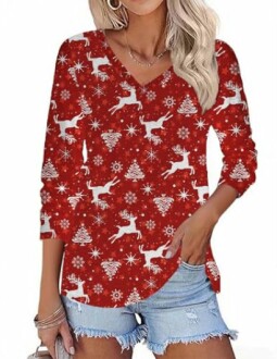 Woman wearing a red Christmas-themed top with reindeer and snowflakes.