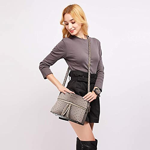 Woman with a gray purse wearing black shorts and gray top