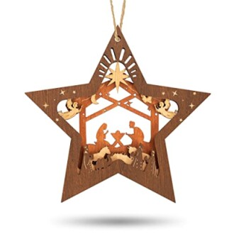 Wooden star ornament with nativity scene cutout.